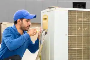 HVAC technician repairing an AC unit
