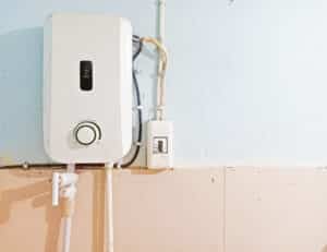 White instant water heater installed on the wall of bathroom 